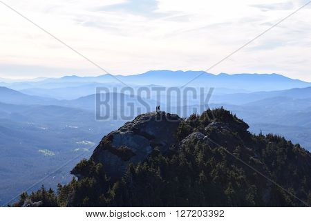 Silhouetted Couple Stands atop mountain inside Blue Ridge Parkway, NC