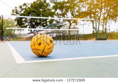 old sepak takraw ball in corner of old blue court