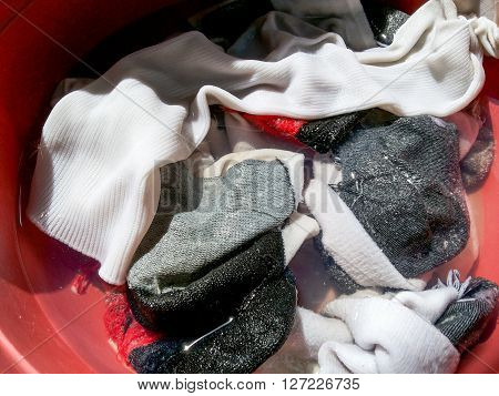 close up fabric sock in plastic washing enamelware