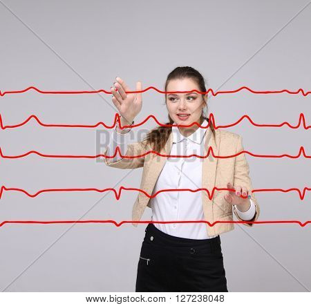 Doctor woman working with cardiogram lines