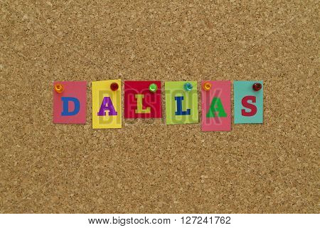 Dallas written on colorful notes pinned on cork board.