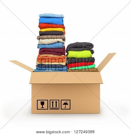 Stack of clothing in cardboard box isolated on white delivery of garments concept
