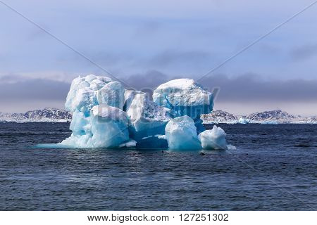 Huge drifting iceberg view from old harbor in Nuuk city Greenland