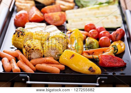 Grilled vegetables, bread and cheese on a grilling pan