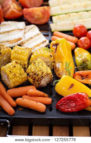 Grilled vegetables, bread and cheese on a grilling pan