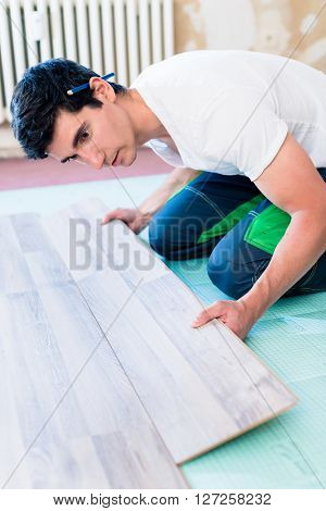 Handyman flooring in home construction site