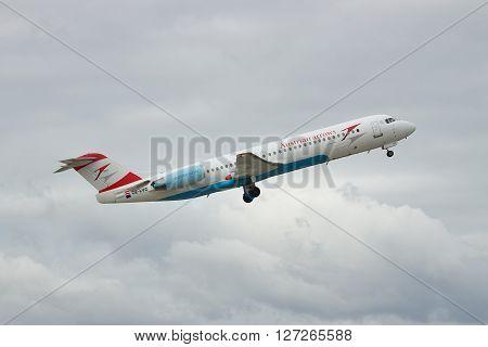 Borispol Ukraine - October 2 2010: Austrian Airlines Fokker 100 passenger plane is taking off into the cloudy sky