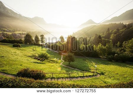 Fantastic views of the morning green garden that glows under sunlight. Dramatic scene. Location: resort Grundlsee, Liezen District of Styria, Austria, Alps. Europe. Beauty world. Instagram effect.