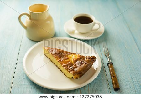 Piece of cake on a white plate on over blue