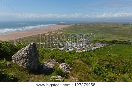View from the top of Rhossili Down to Burry Holms and Hillend The Gower peninsula Wales UK in summer with caravans and camping on the campsite