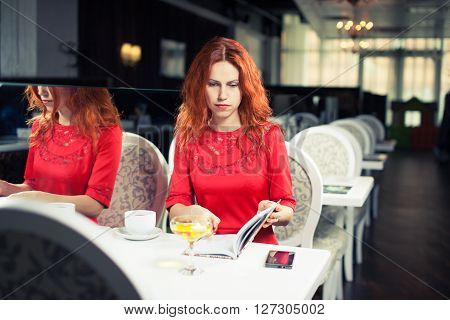 outdoor portrait of a young girl she works as a freelancer in a cafe drinking a delicious hot Cup of coffee from text send mail loads the photo instagram freelancer drinking cappuccino