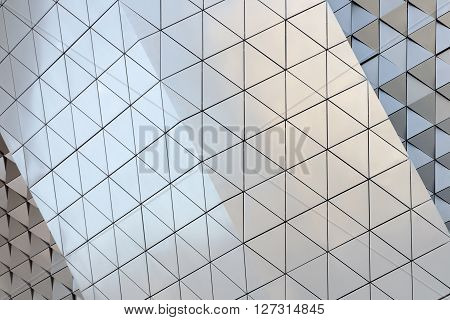 Abstract close-up view of modern aluminum ventilated facade of triangles