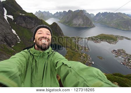 Tourist selfie in Norway - view from Reinebringen hiking trail in Lofoten islands.