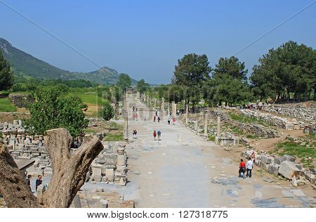 EPHESUS, TURKEY - APRIL 30, 2012: Tourists in Ephesus, Turkey. Ephesus was an ancient Greek city on the coast of Ionia, three kilometres southwest of present-day Selcuk in zmir Province, Turkey