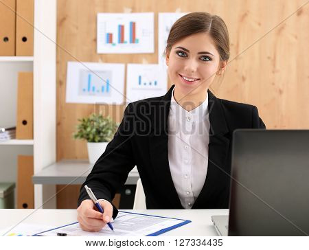 Beautiful businesswoman sit at workplace in office work with papers portrait. Serious business, exchange market, job offer, analytics researc, excellent education, certified public accountant concept
