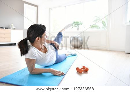 Woman doing workout exercises at home