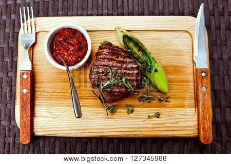 Beautiful Juicy Well Done Steak With Sauce On A Wooden Board