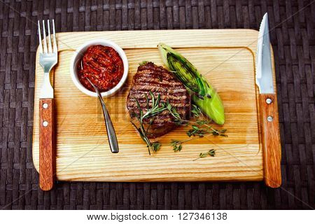 Beautiful Juicy Well Done Steak With Sauce On A Wooden Board