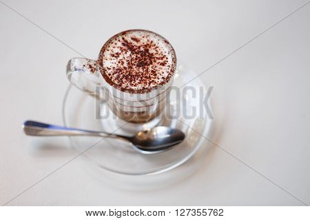 Italian traditional coffee macciato, made in Milan. This beverage contains dark chocolate, hot frothed milk and espresso.