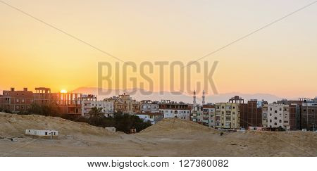 city on the edge of the desert during the evening twilight