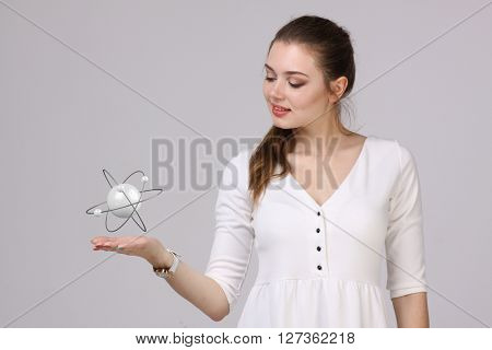 Woman scientist with atom model, research concept