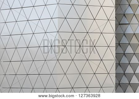 Abstract close-up view of modern aluminum ventilated facade of triangles