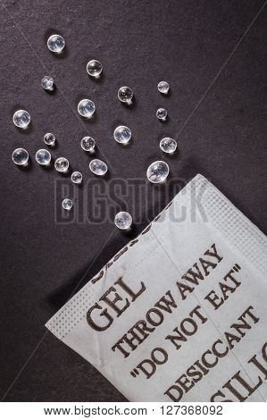 Close Up Silica Gel Or Desiccant In Paper Bag On Black Background