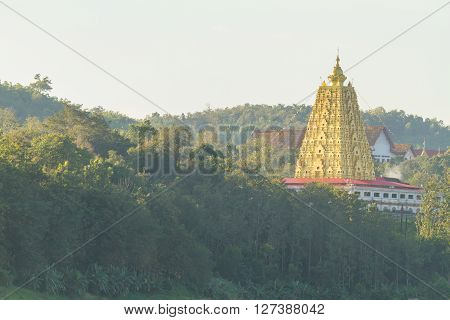 Wat Wang Wiwekaram, Kanchanaburi,Thailand - December 17,2013 : Golden pagoda temple on the mountain