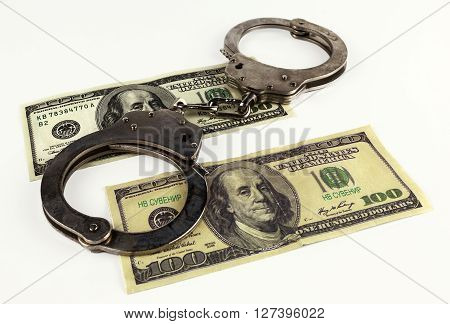fake dollars with handcuffs isolated on white background.