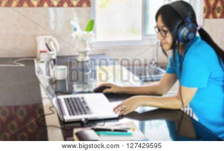 Blurred Picture Of Relaxing Life Style Asian Girl Serfing Internet Or Data Search On Notebook At Cou