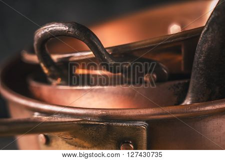 Copper pots and pans close-up background, stack, close-up, macro
