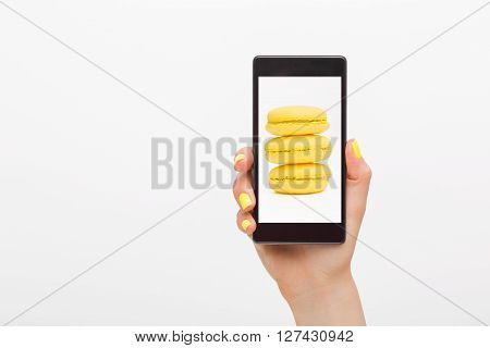 Person showing picture of macroons in cellphone