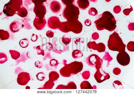 Red juicy spots on white background different shapes