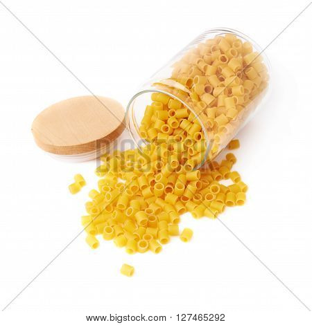 Glass jar filled with dry ditalini yellow pasta over isolated white background