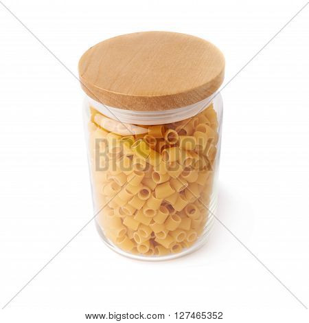 Glass jar filled with dry ditalini yellow pasta over isolated white background
