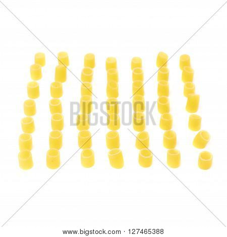 Single pieces of dry ditalini yellow pasta over isolated white background
