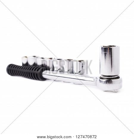 Wrench with line of metal sockets over white isolated background