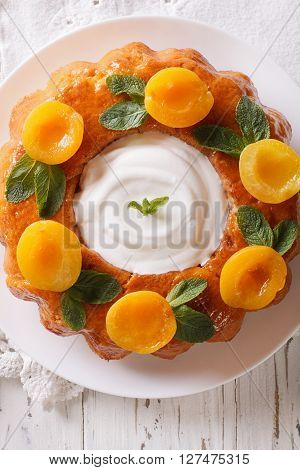 Tasty Cake Savarin With Apricots And Mint Close-up. Vertical Top View