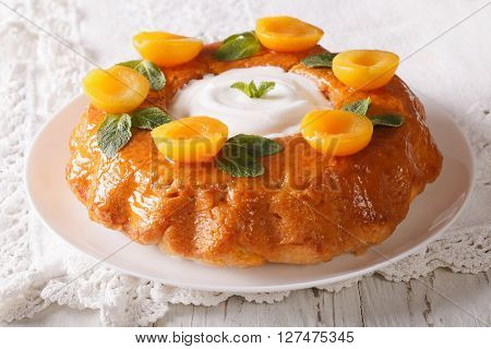 Tasty Cake Savarin With Apricots And Mint Close-up. Horizontal