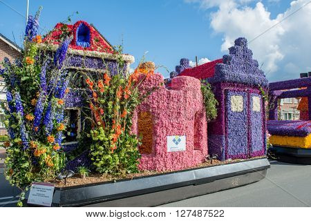 HILLEGOM, THE NETHERLANDS - APRIL 23, 2016: Platform with a frame made in a form of fairy houses and decorated with flowers. Part of the  traditional flowers parade 