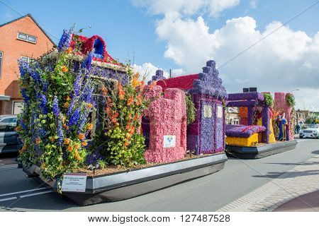 HILLEGOM, THE NETHERLANDS - APRIL 23, 2016: Platform with a frame made in a form of fairy houses and decorated with flowers. Part of the  traditional flowers parade 