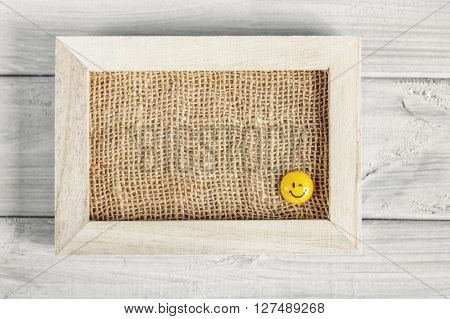 Frame with smiles on a wooden board.