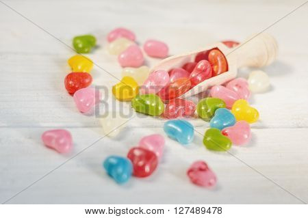 Colored pills in the kitchen measuring spoon.