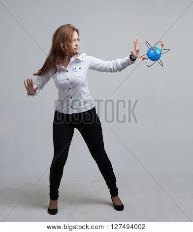 Woman scientist with atom model, research concept