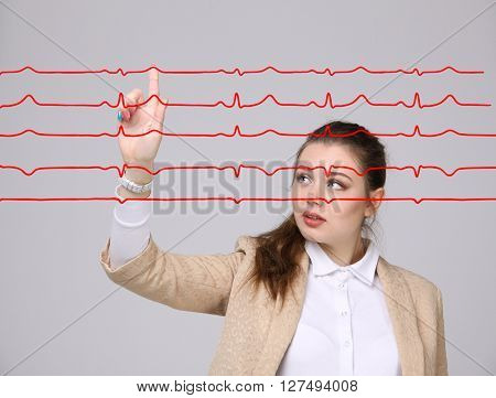 Doctor woman working with cardiogram lines