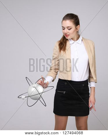 Woman scientist with atom model, research concept