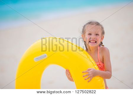 Adorable little girl at beach during summer vacation