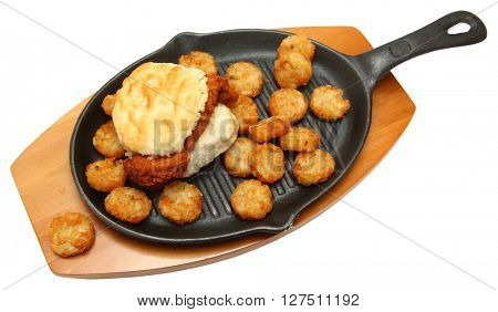 Spicy Chicken Biscuit and Hashbrowns on Skillet isolated over white
