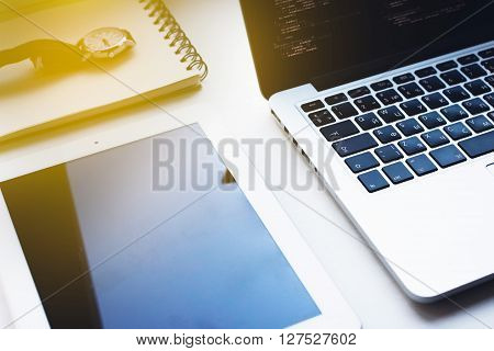 office tools on white table, tablet, laptop, watch