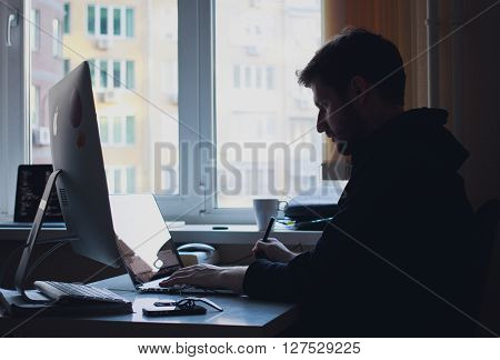 man sitting at a desktop computer in the office